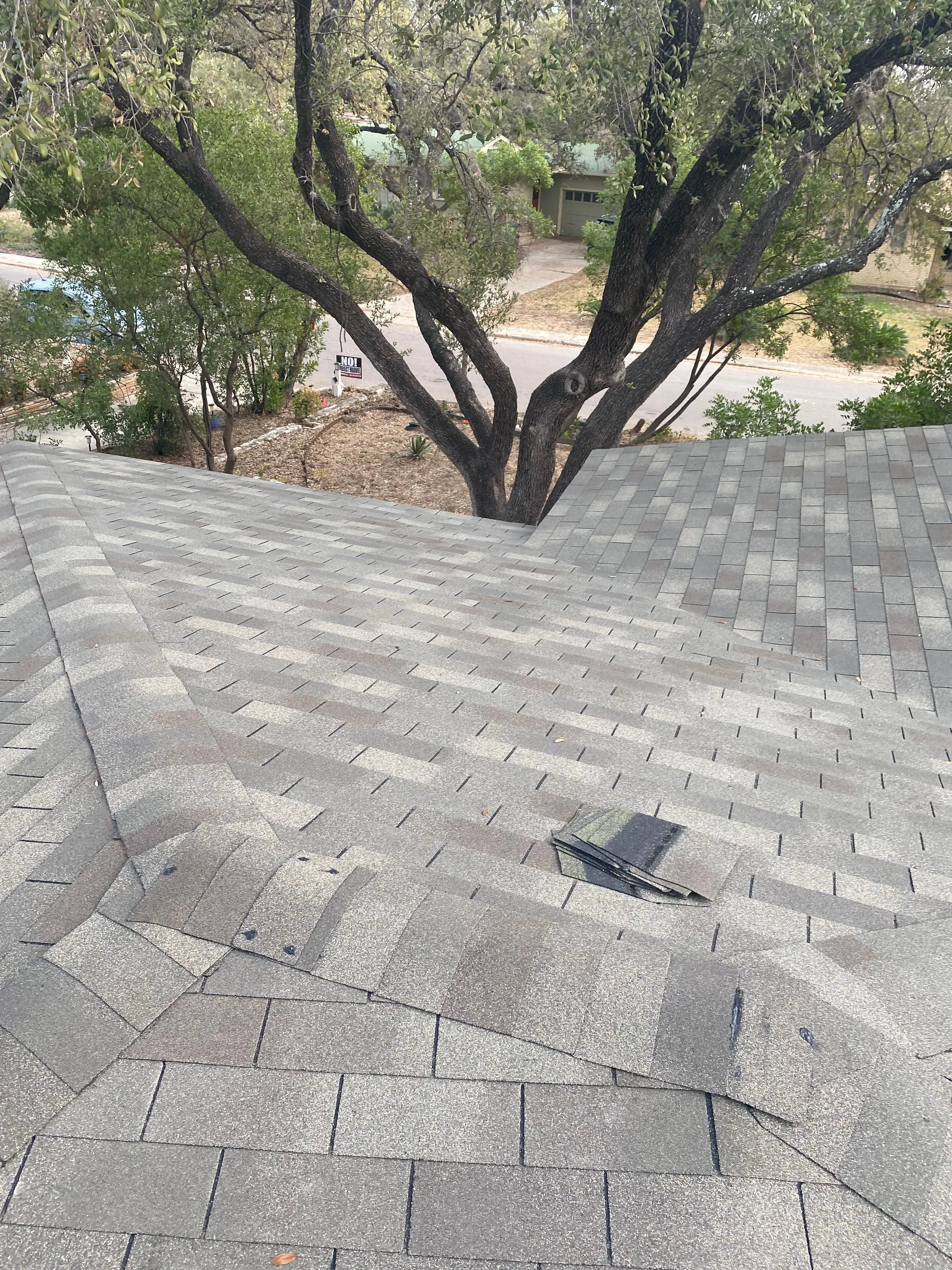 Gray asphalt shingles installed in herringbone pattern on residential roof