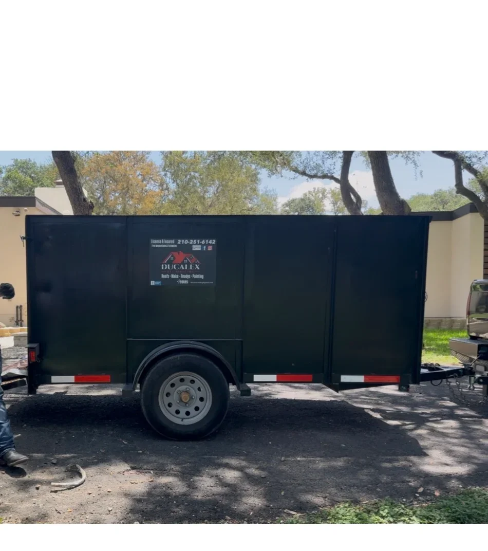 Navy enclosed trailer with white Ducalex logo and contact details, red and white safety striping