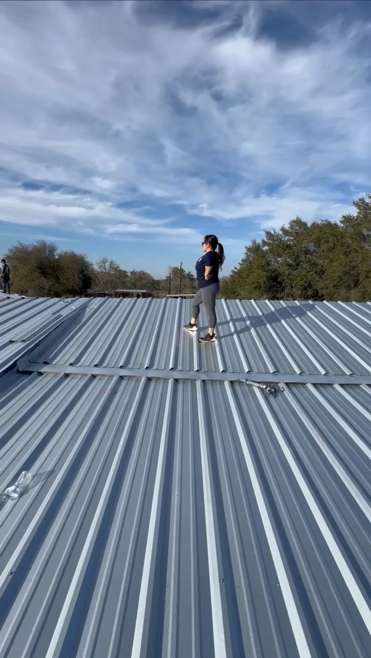Standing seam metal roof with gray and white corrugated panels installed on residential structure