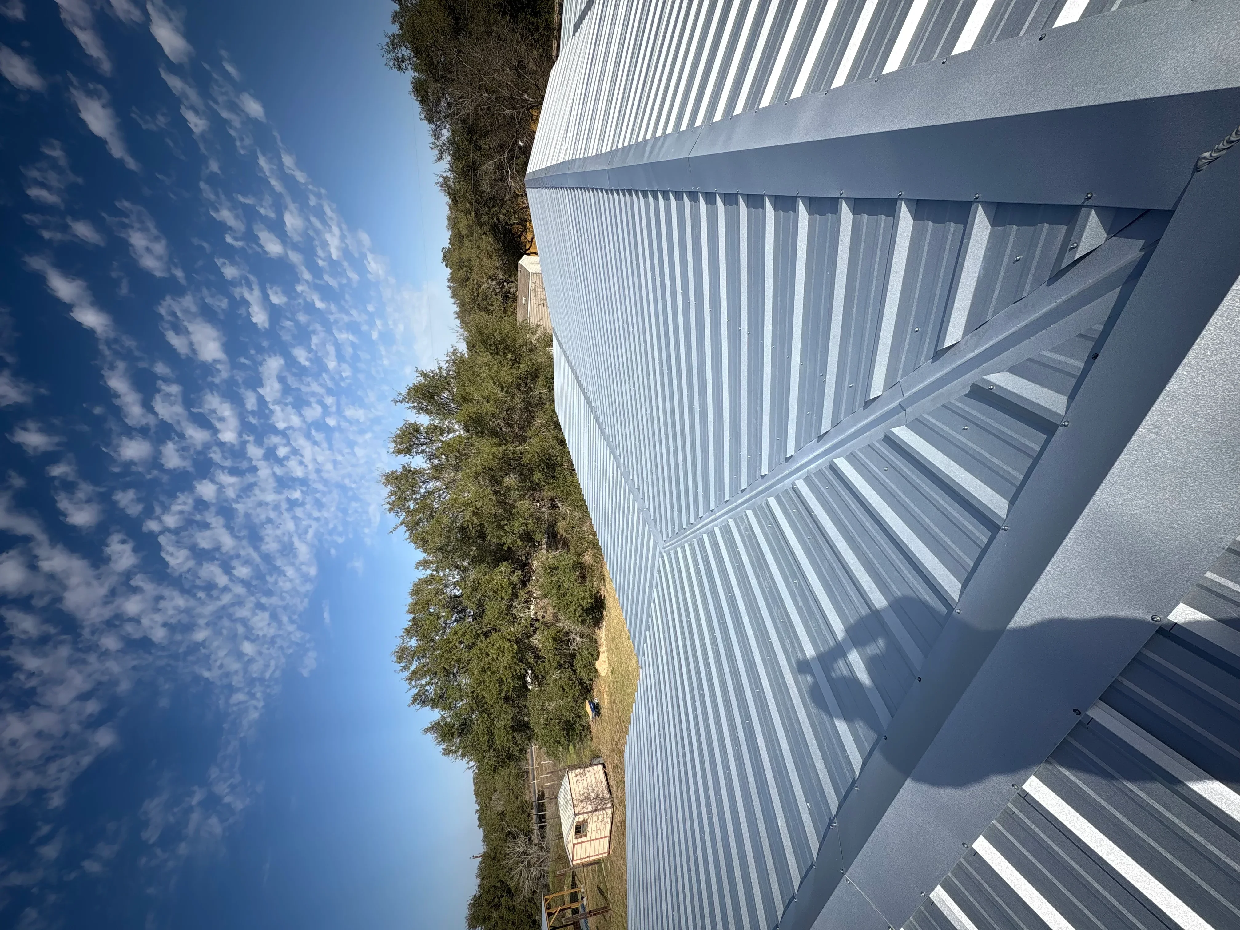 White corrugated metal roof panels with vertical ribs installed on commercial building
