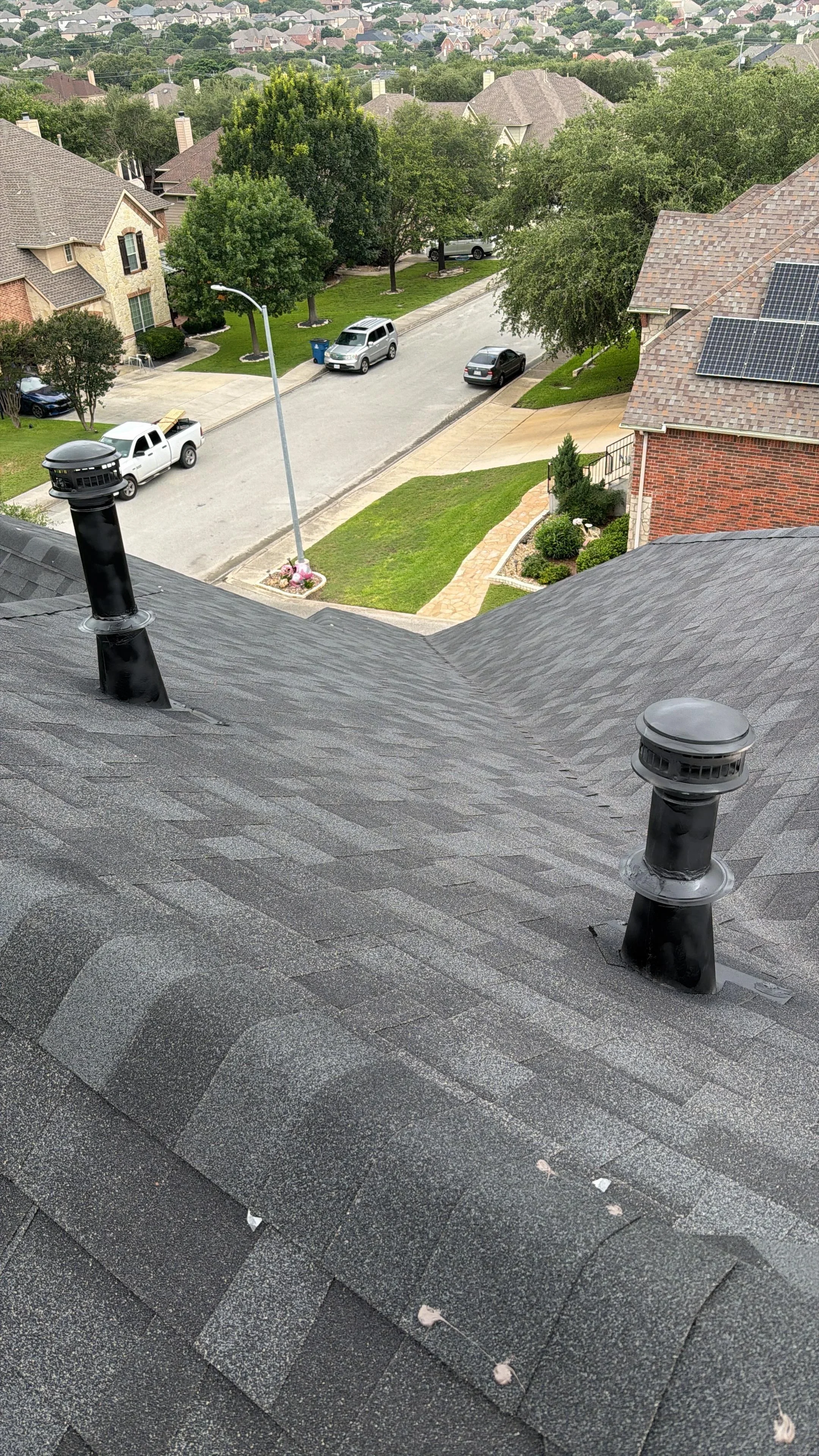 Gray architectural shingles with roof vents installed on residential home
