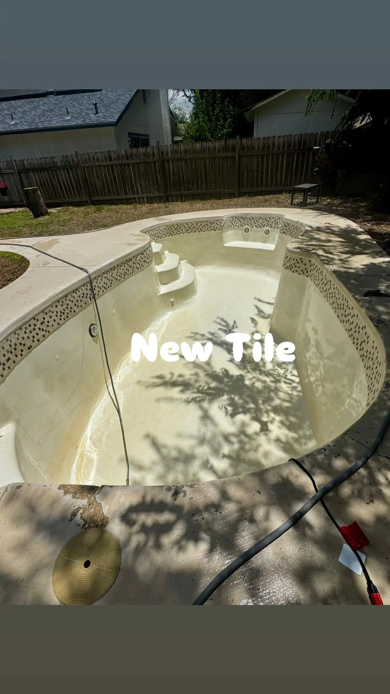 Empty in-ground pool with concrete deck after pressure washing and cleaning restoration